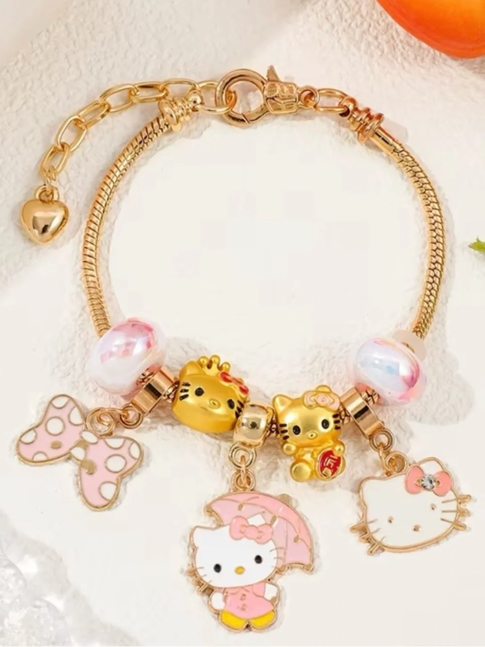 Hello Kitty Gold-Tone Pink Charm Bracelet for Kids.